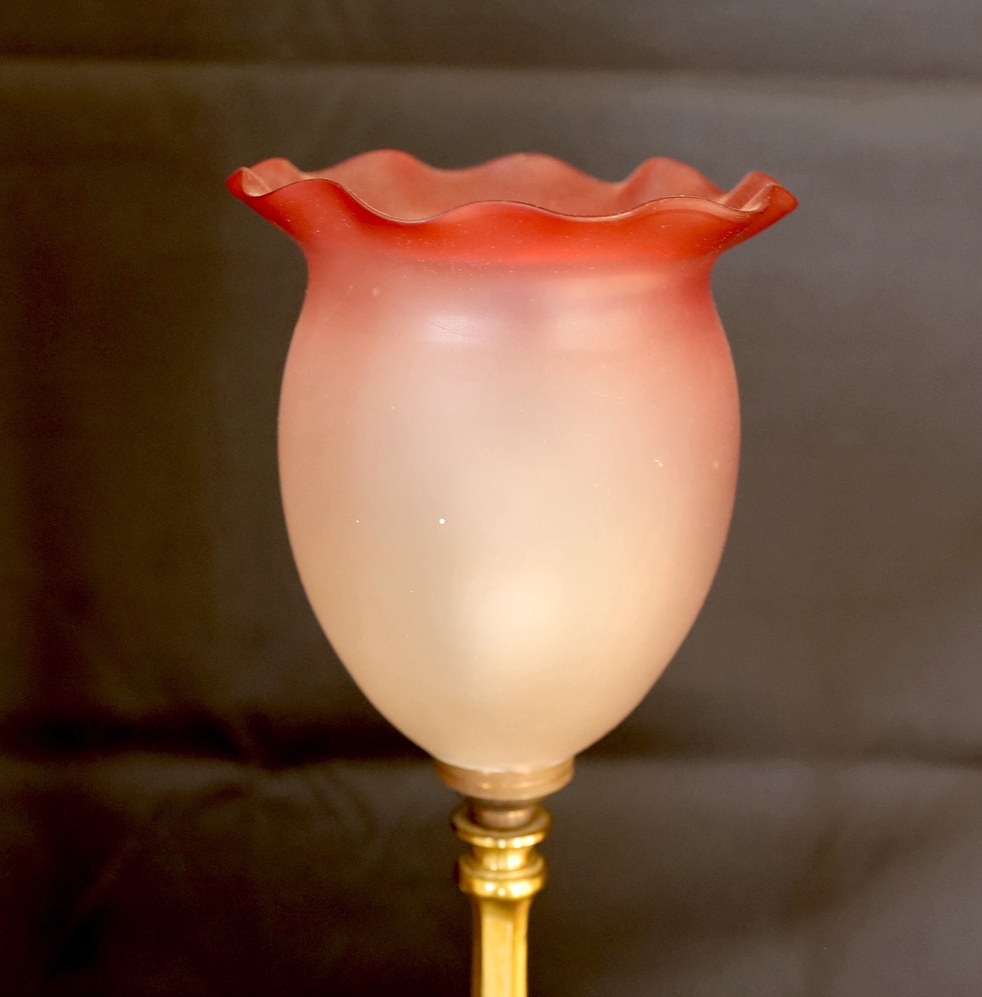 An early 20th century English brass table lamp with associated tinted and frosted glass shade, height overall 44cm